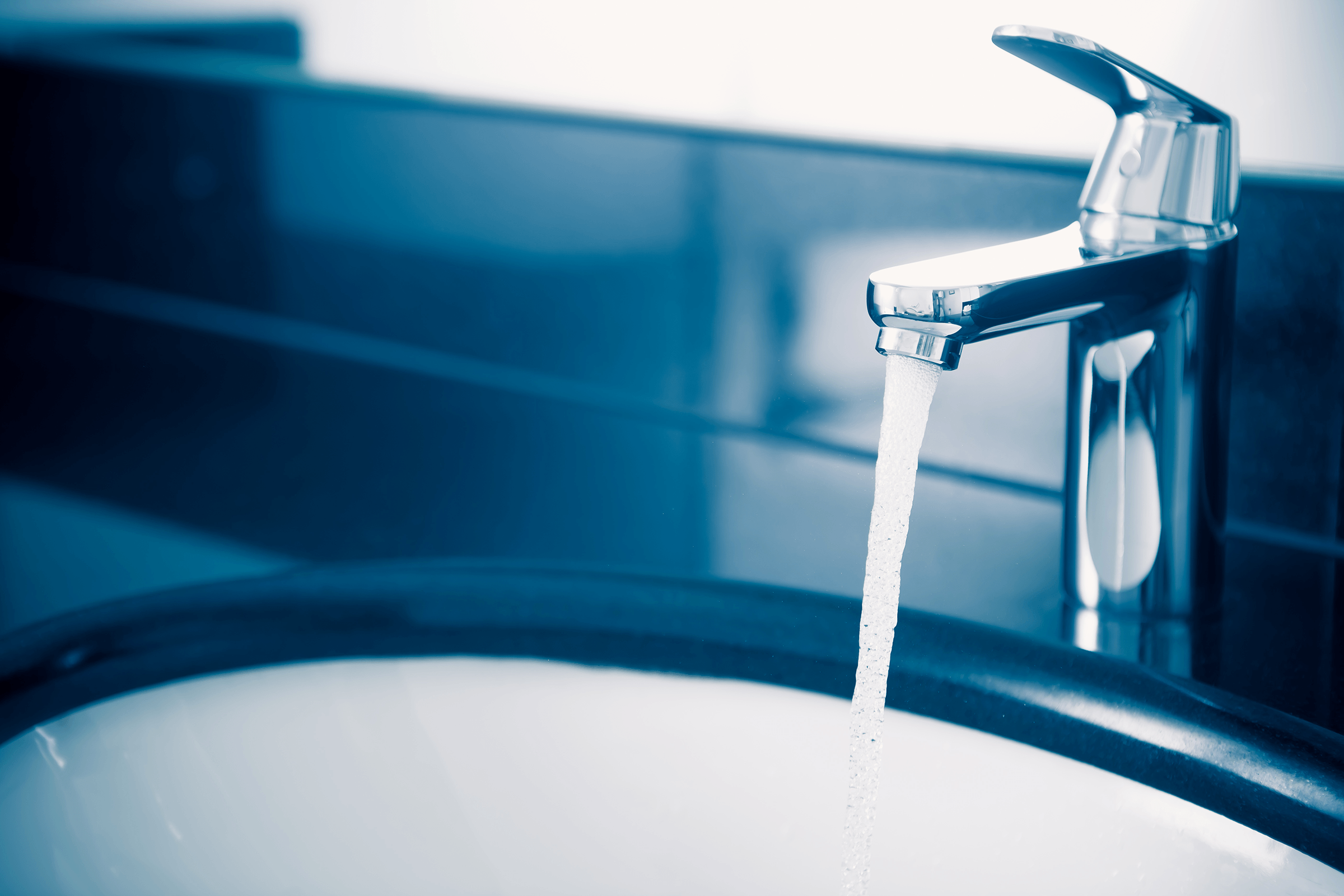 Image of water flowing from a residential faucet